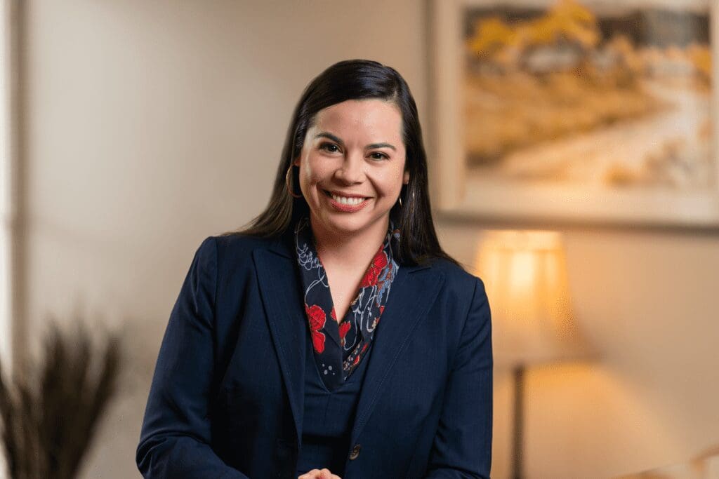 Smiling professional woman in navy suit Smiling woman in navy blazer indoors